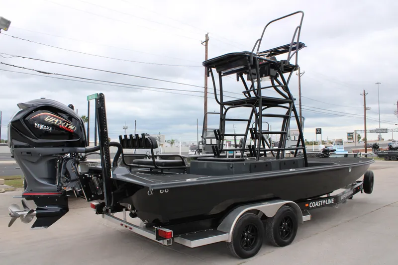 Slide: The Image of Control panel of 2025 Mamba 24 Catamaran Elite with steering wheel and switches. - 14