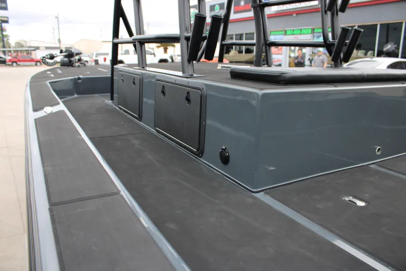 Slide: The Image of 2025 Mamba 24 Catamaran Elite boat deck with seating, displayed at a dealership. - 19