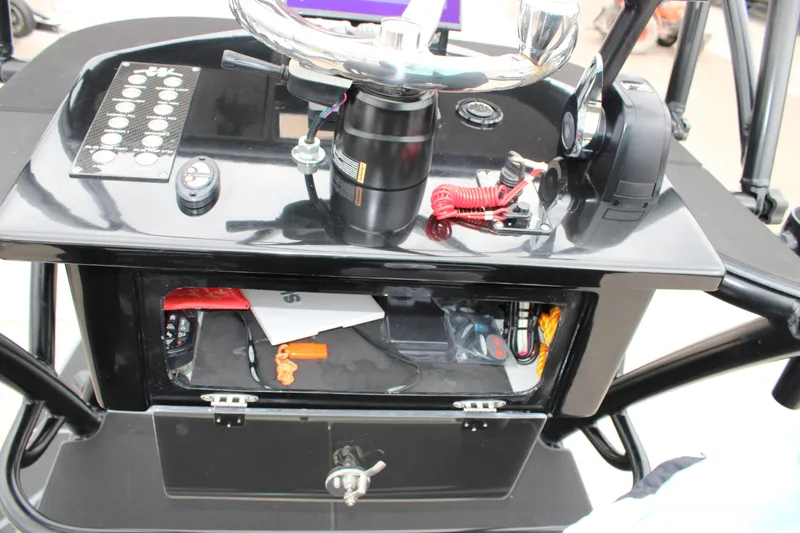 Slide: The Image of 2025 Mamba 24 Catamaran Elite dashboard with steering wheel and control panel. - 3