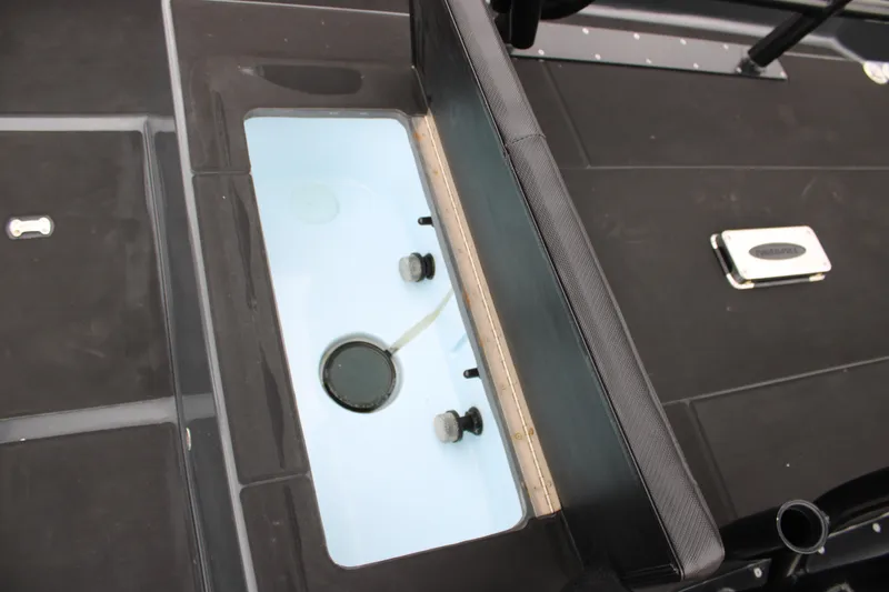 Slide: The Image of 2025 Mamba 24 Catamaran Elite livewell with open seat, showcasing storage and functionality. - 32