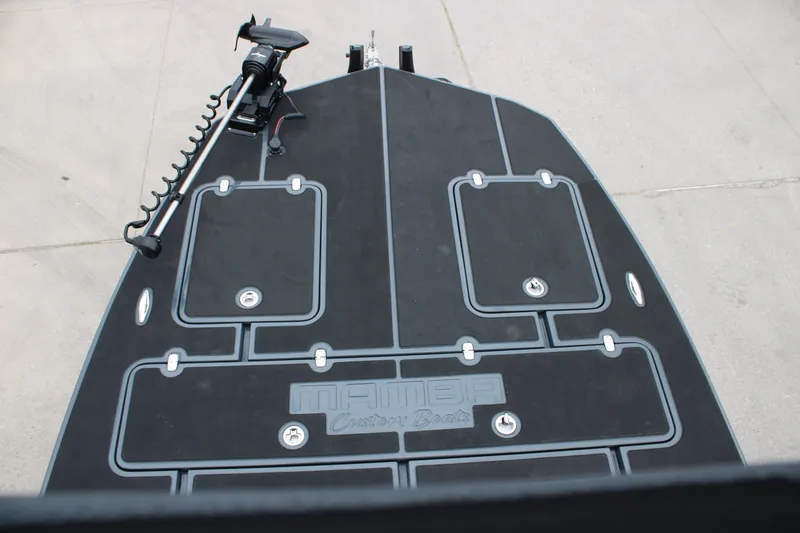 Slide: The Image of 2025 Mamba 24 Catamaran Elite outboard motor with dual propellers on concrete surface. - 4