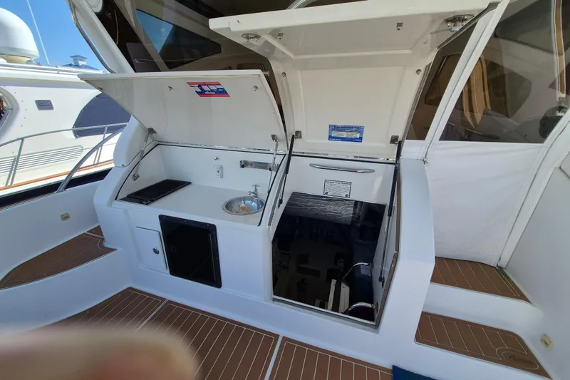 Slide: The Image of 2003 Navigator Californian Veneti yacht interior with open storage compartments and sink. - 10