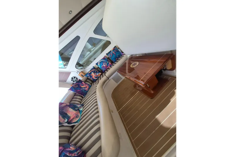 Slide: The Image of Interior of 2003 Navigator Californian Veneti yacht with striped seating and colorful cushions. - 18