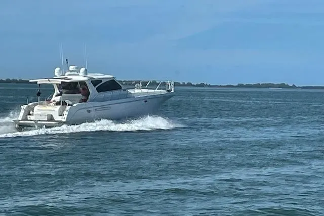 Slide: The Image of A 2003 Navigator Californian Veneti yacht cruising on open water under a clear blue sky. - 2