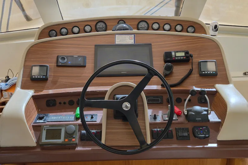 Slide: The Image of 2003 Navigator Californian Veneti yacht helm with steering wheel and navigation controls. - 21