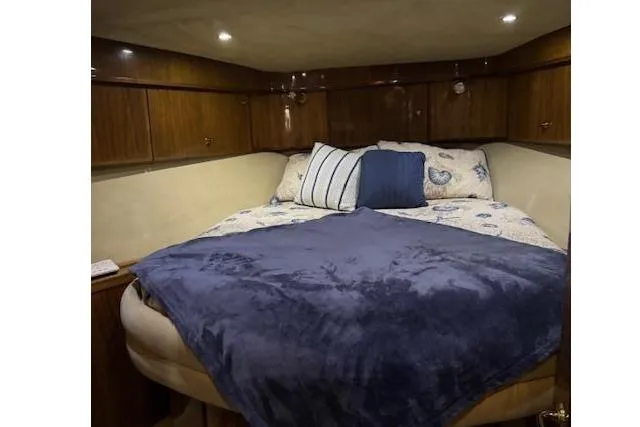 Slide: The Image of Cozy cabin interior of 2003 Navigator Californian Veneti yacht with plush bedding and wooden cabinets. - 28