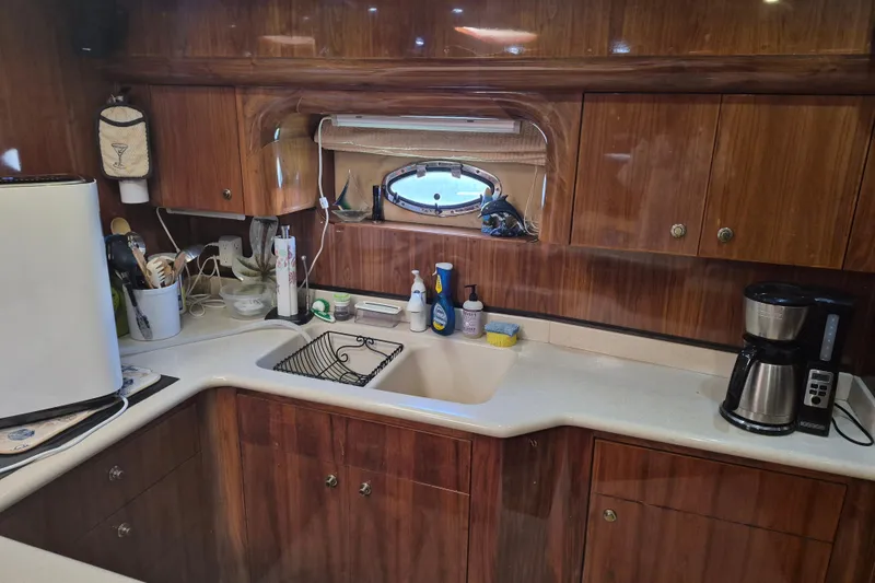 Slide: The Image of Luxurious yacht kitchen interior with wooden cabinets, sink, and appliances in a 2003 Navigator Californian Veneti. - 35