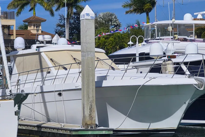 Slide: The Image of 2003 Navigator Californian Veneti yacht docked at marina with palm trees in background. - 4