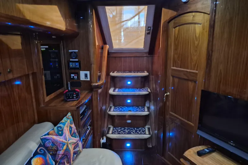Slide: The Image of Interior of a 2003 Navigator Californian Veneti yacht with wood paneling and blue lighting. - 40
