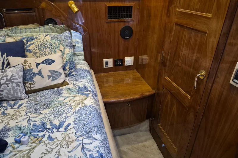 Slide: The Image of Luxurious 2003 Navigator Californian Veneti yacht cabin with nautical-themed bedding and wooden interior. - 45