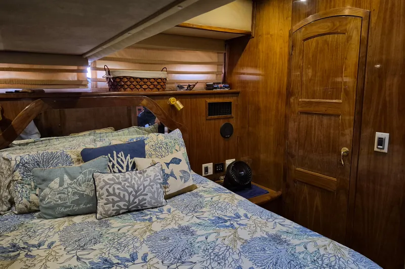 Slide: The Image of Luxurious 2003 Navigator Californian Veneti yacht bedroom with nautical-themed bedding and wooden interior. - 48