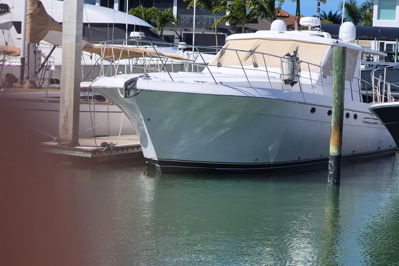 Slide: The Image of 2003 Navigator Californian Veneti yacht docked in a marina, surrounded by calm water. - 5
