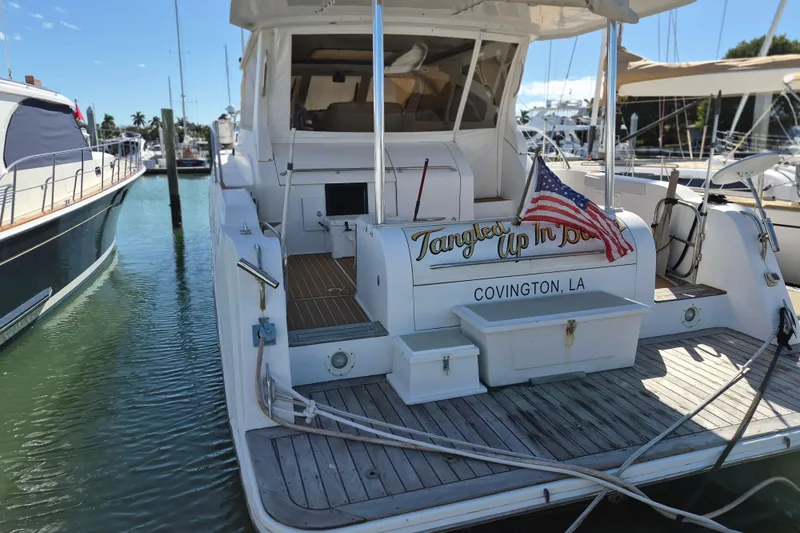 Slide: The Image of 2003 Navigator Californian Veneti yacht docked, displaying "Tangled Up In Blue" and American flag. - 6