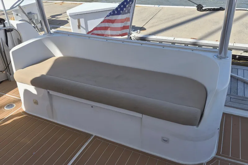 Slide: The Image of 2003 Navigator Californian Veneti boat seating area with American flag in background. - 9