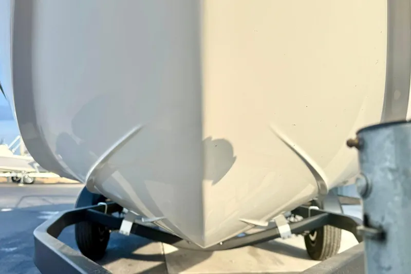 Slide: The Image of 2024 Chaparral 19 SSi OB boat hull on trailer, close-up view. - 10