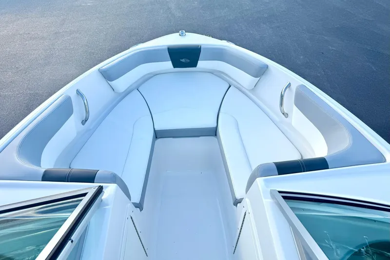 Slide: The Image of 2024 Chaparral 19 SSi OB boat interior with white cushioned seating. - 12