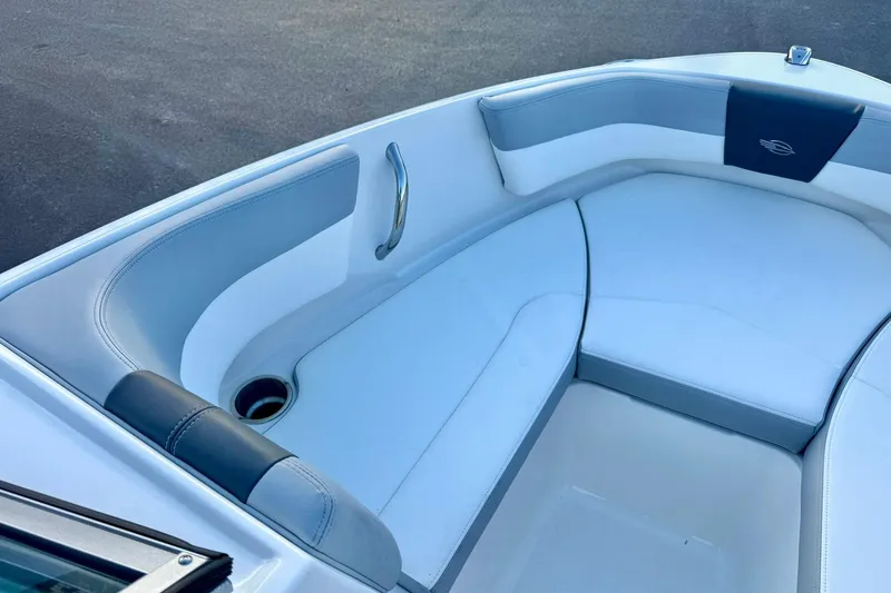Slide: The Image of 2024 Chaparral 19 SSi OB boat interior with cushioned seating and cup holder. - 13