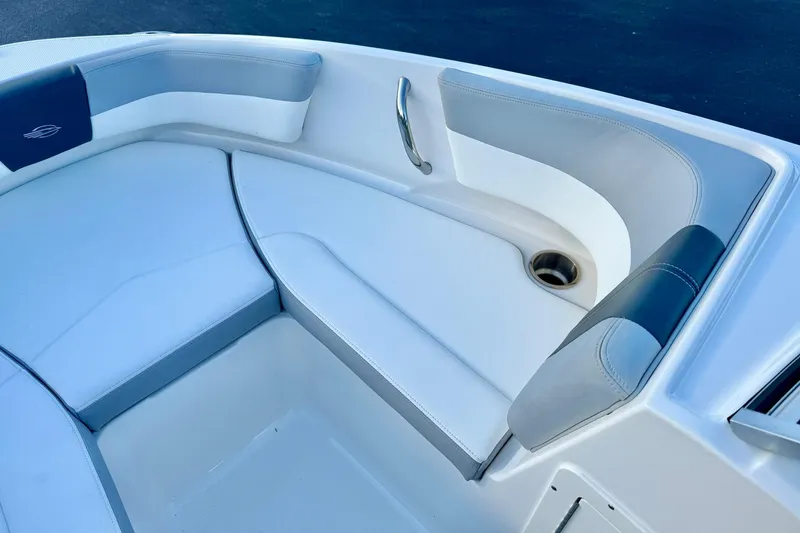 Slide: The Image of 2024 Chaparral 19 SSi OB boat interior with cushioned seating and stainless steel handle. - 15