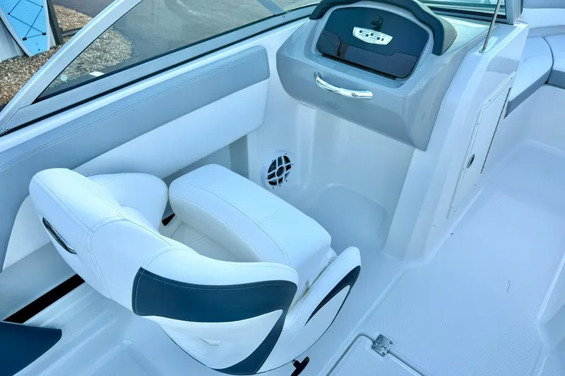 Slide: The Image of 2024 Chaparral 19 SSi OB boat interior with white seating and dashboard. - 18