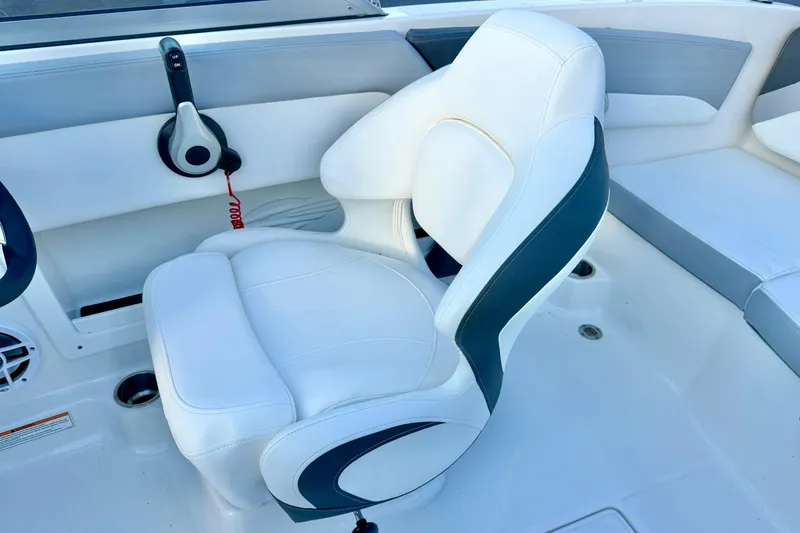 Slide: The Image of 2024 Chaparral 19 SSi OB boat interior with white and gray seating. - 29