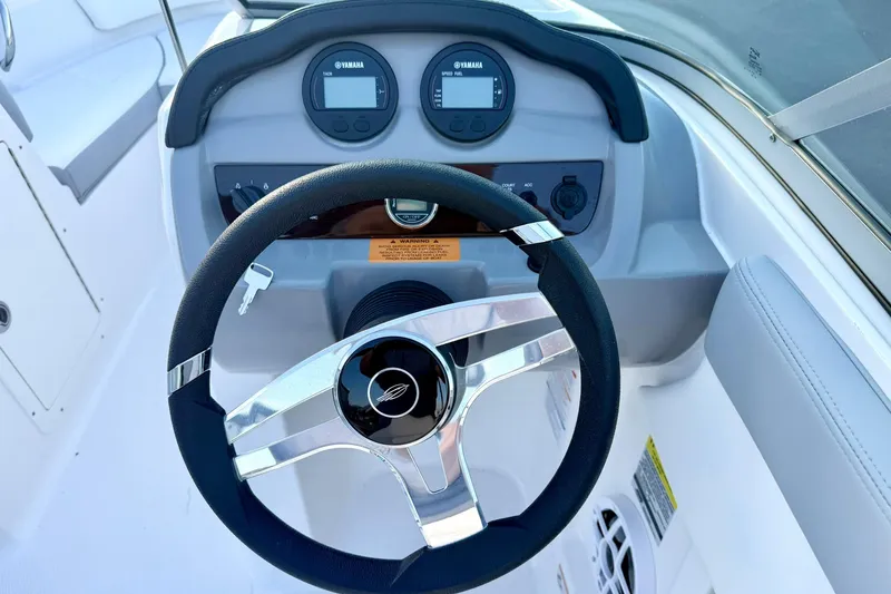 Slide: The Image of 2024 Chaparral 19 SSi OB boat dashboard with steering wheel and Yamaha gauges. - 3