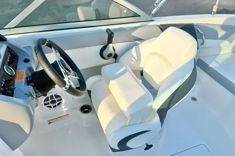 Slide: The Image of 2024 Chaparral 19 SSi OB boat interior with steering wheel and white seating. - 30