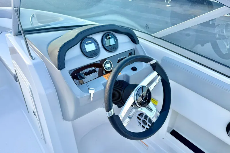Slide: The Image of 2024 Chaparral 19 SSi OB boat dashboard with steering wheel and gauges. - 31