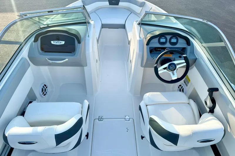 Slide: The Image of 2024 Chaparral 19 SSi OB boat interior with dual white seats and modern dashboard. - 32