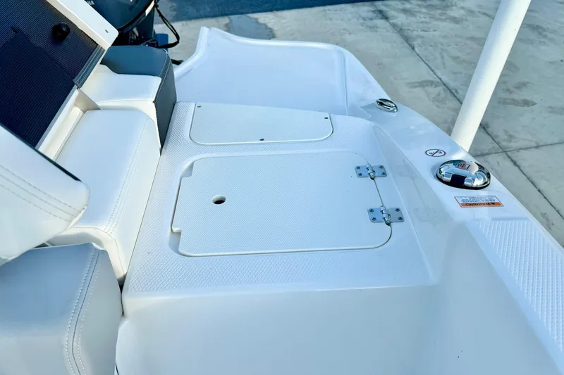 Slide: The Image of 2024 Chaparral 19 SSi OB boat deck with storage compartment and seating. - 41