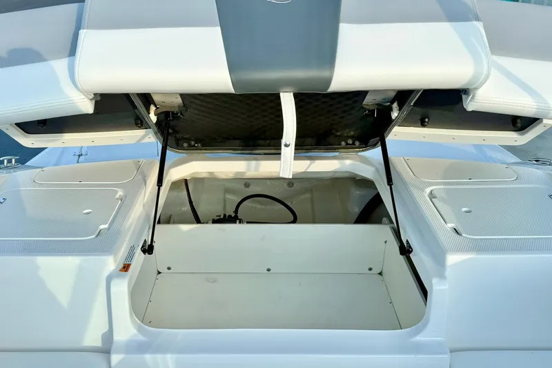 Slide: The Image of 2024 Chaparral 19 SSi OB boat storage compartment with open hatch. - 44