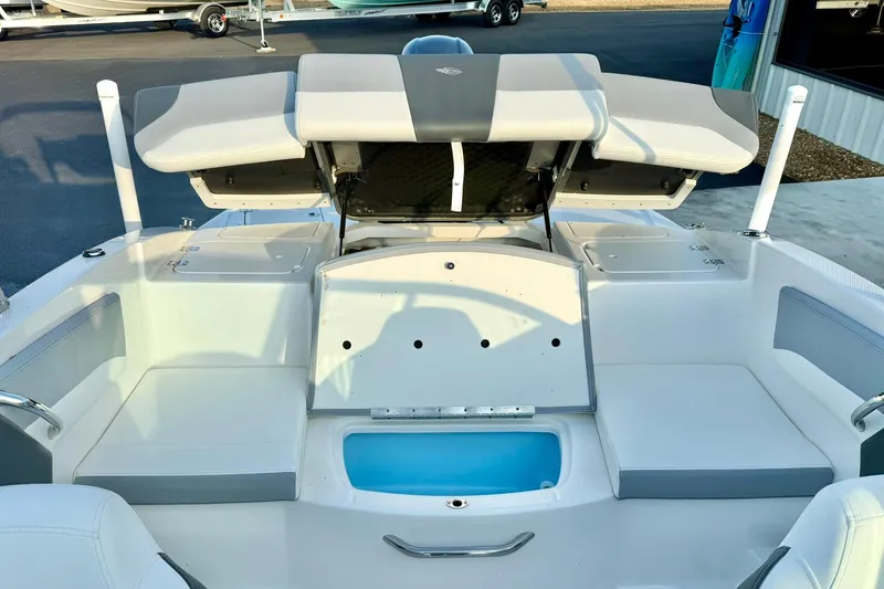 Slide: The Image of 2024 Chaparral 19 SSi OB boat interior with seating and storage compartments. - 49