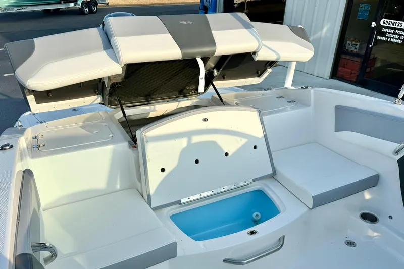 Slide: The Image of 2024 Chaparral 19 SSi OB boat interior with open storage compartments and seating. - 50