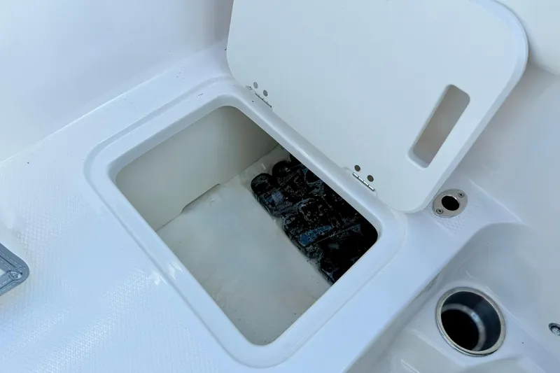 Slide: The Image of 2024 Chaparral 19 SSi OB boat storage compartment with open lid. - 53