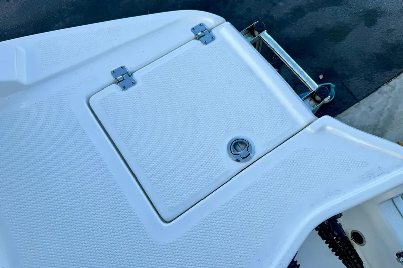 Slide: The Image of 2024 Chaparral 19 SSi OB boat deck with storage compartment and ladder. - 62