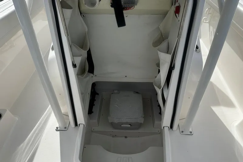 Slide: The Image of 2019 Wellcraft 222 Fisherman boat interior with storage compartments and seating. - 10
