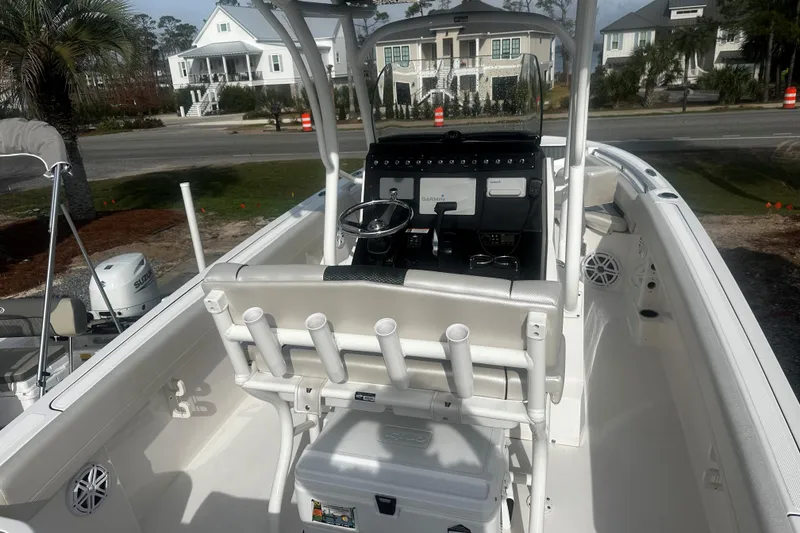 Slide: The Image of 2019 Wellcraft 222 Fisherman boat interior with steering console and rod holders. - 4