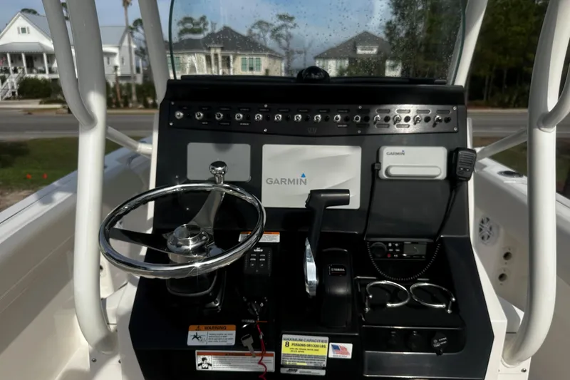 Slide: The Image of 2019 Wellcraft 222 Fisherman boat console with Garmin navigation system and steering wheel. - 5