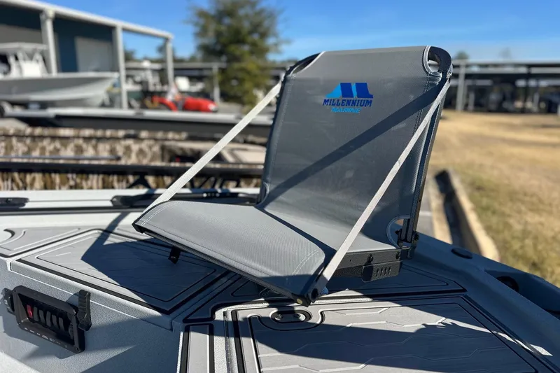 Slide: The Image of Millennium Marine seat on 2026 Avid 18 Commander boat deck, outdoor setting. - 10