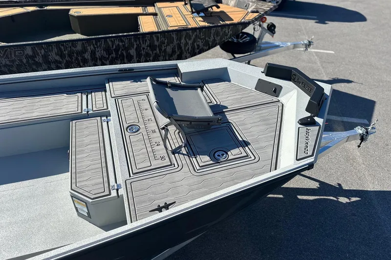 Slide: The Image of 2026 Avid 18 Commander boat with sleek deck design and measurement markings. - 11