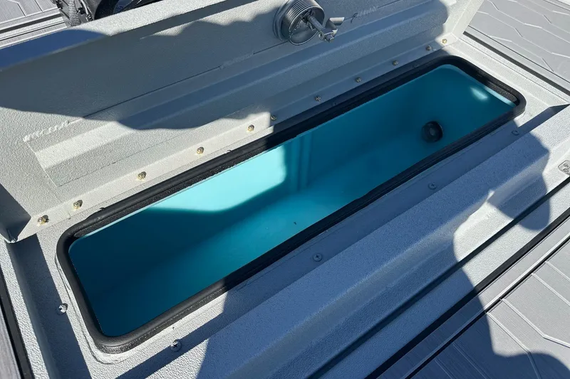 Slide: The Image of Open storage compartment on 2026 Avid 18 Commander boat, showing interior details. - 16