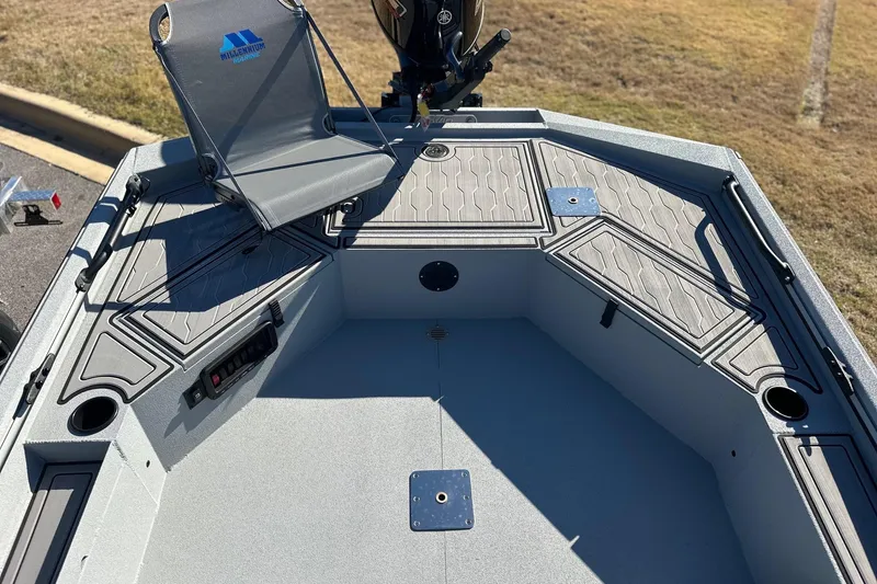 Slide: The Image of 2026 Avid 18 Commander boat interior with seating and storage compartments. - 18