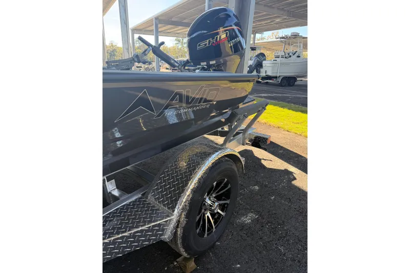 Slide: The Image of 2026 Avid 18 Commander boat on trailer, featuring sleek design and powerful engine. - 2