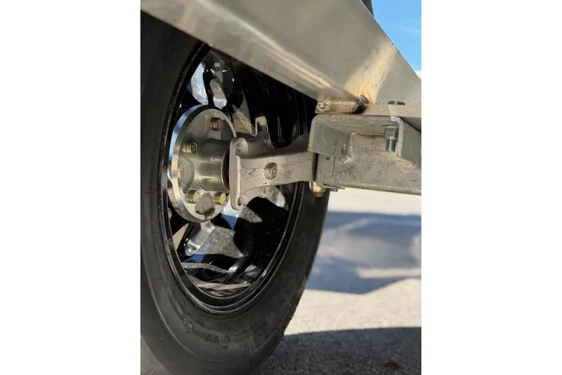 Slide: The Image of Close-up of a 2026 Avid 18 Commander wheel and suspension system. - 21