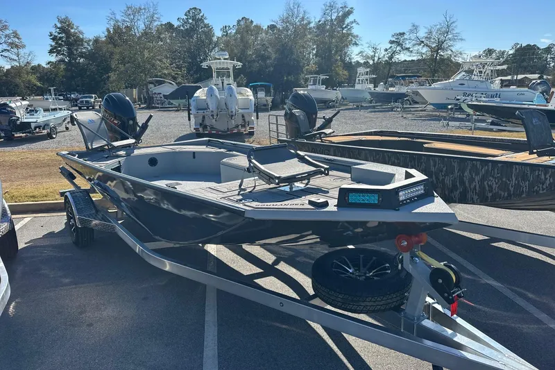 Slide: The Image of 2026 Avid 18 Commander boat on trailer in a marina parking lot. - 3