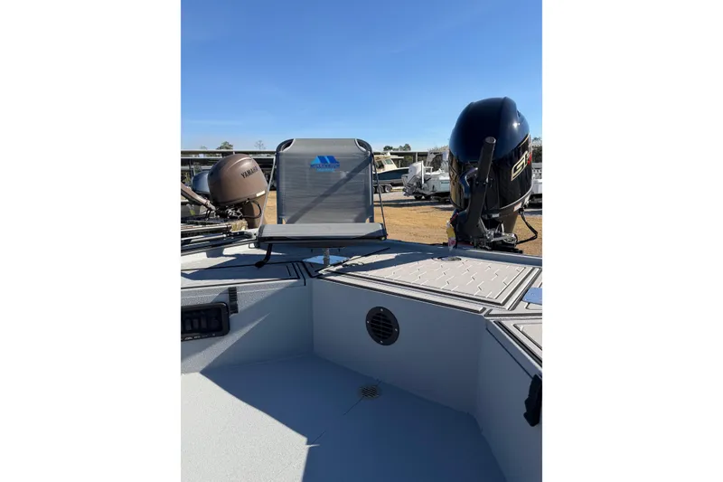 Slide: The Image of 2026 Avid 18 Commander boat interior with Yamaha outboard motors, featuring seating and storage compartments. - 5
