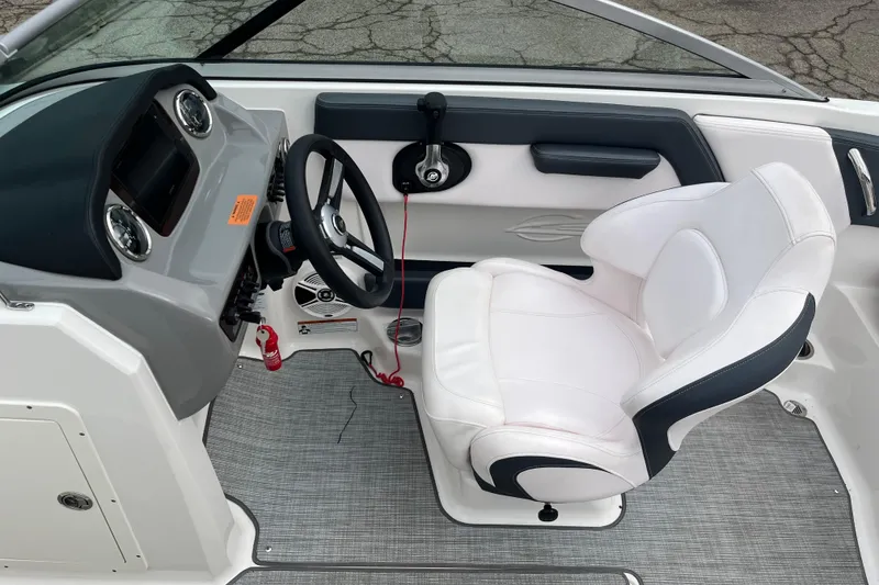 Slide: The Image of 2020 Chaparral 21 SSi Ski & Fish boat interior with steering wheel and white captain's chair. - 19