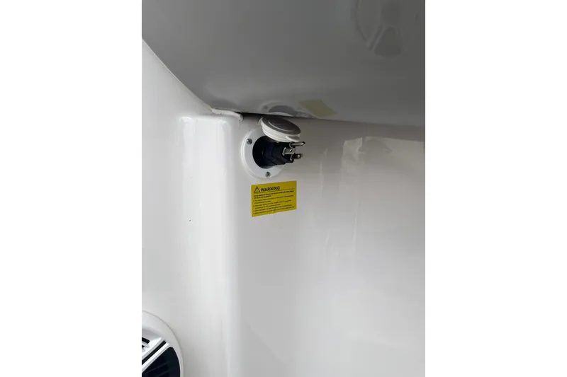 Slide: The Image of 2020 Chaparral 21 SSi Ski & Fish boat detail with warning label and plug socket. - 20