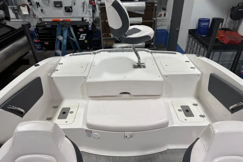 Slide: The Image of 2020 Chaparral 21 SSi Ski & Fish boat interior with seating and storage compartments. - 23