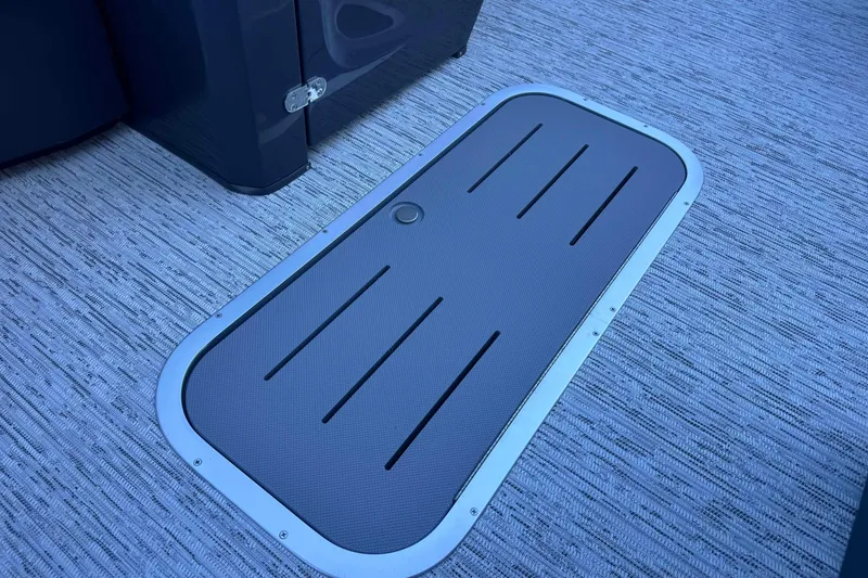 Slide: The Image of Floor hatch on 2026 Bennington 23 SSR boat, featuring textured surface and sleek design. - 11