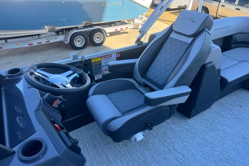 Slide: The Image of 2026 Bennington 23 SSR boat interior with luxury captain's chair and steering wheel. - 12